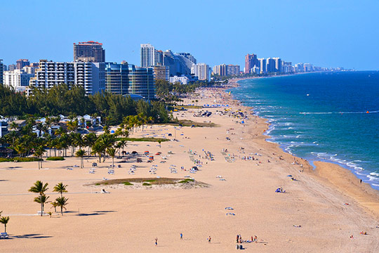 Photograph of a popular beach with many vulnerable structures exposed to the rising seas.